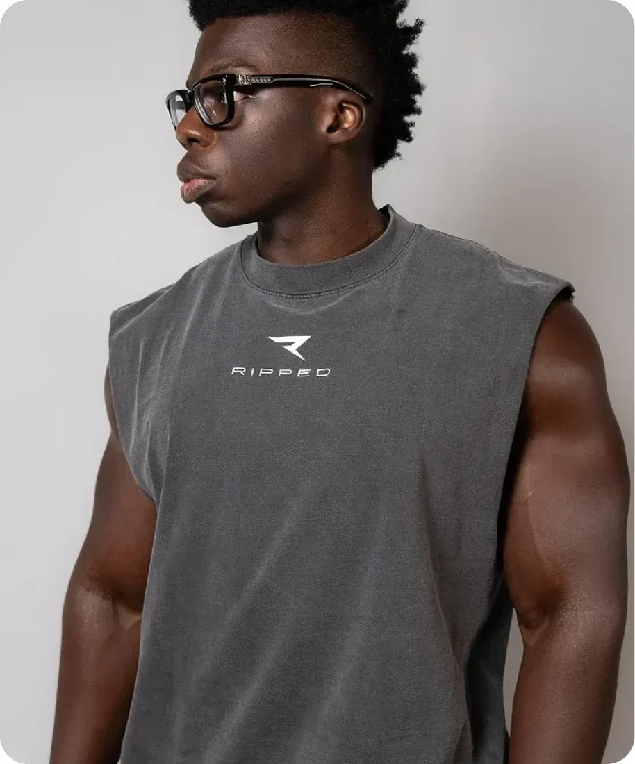 An athlete in a grey RIPPED cut-off tee