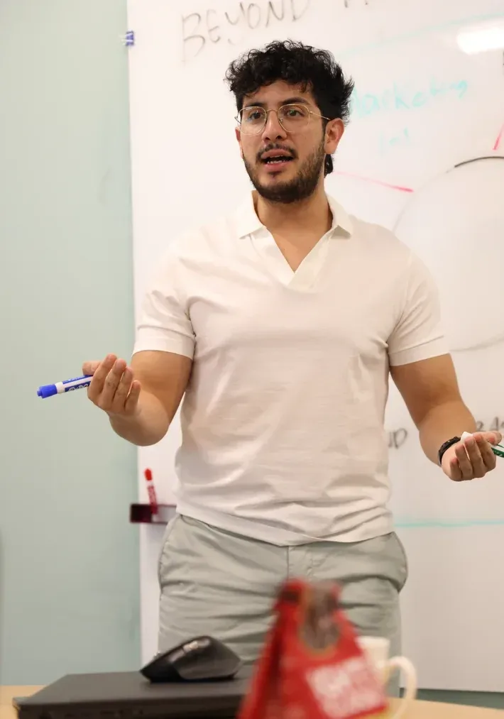 A team member presenting at a whiteboard