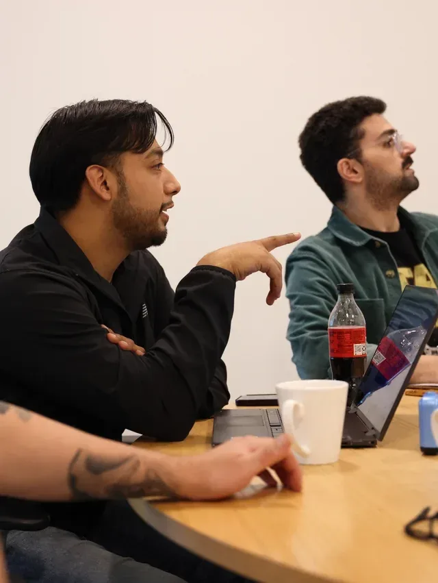 Two team members in discussion at a meeting table