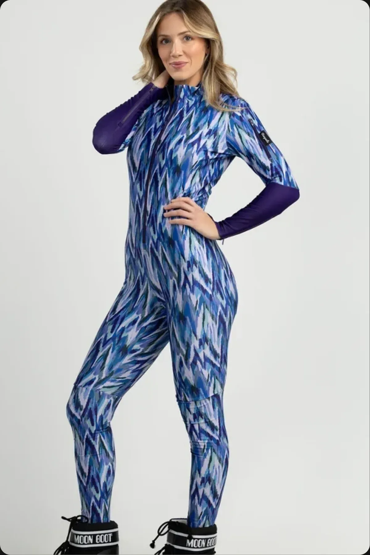 A model in a blue patterned Racysuits ski suit
