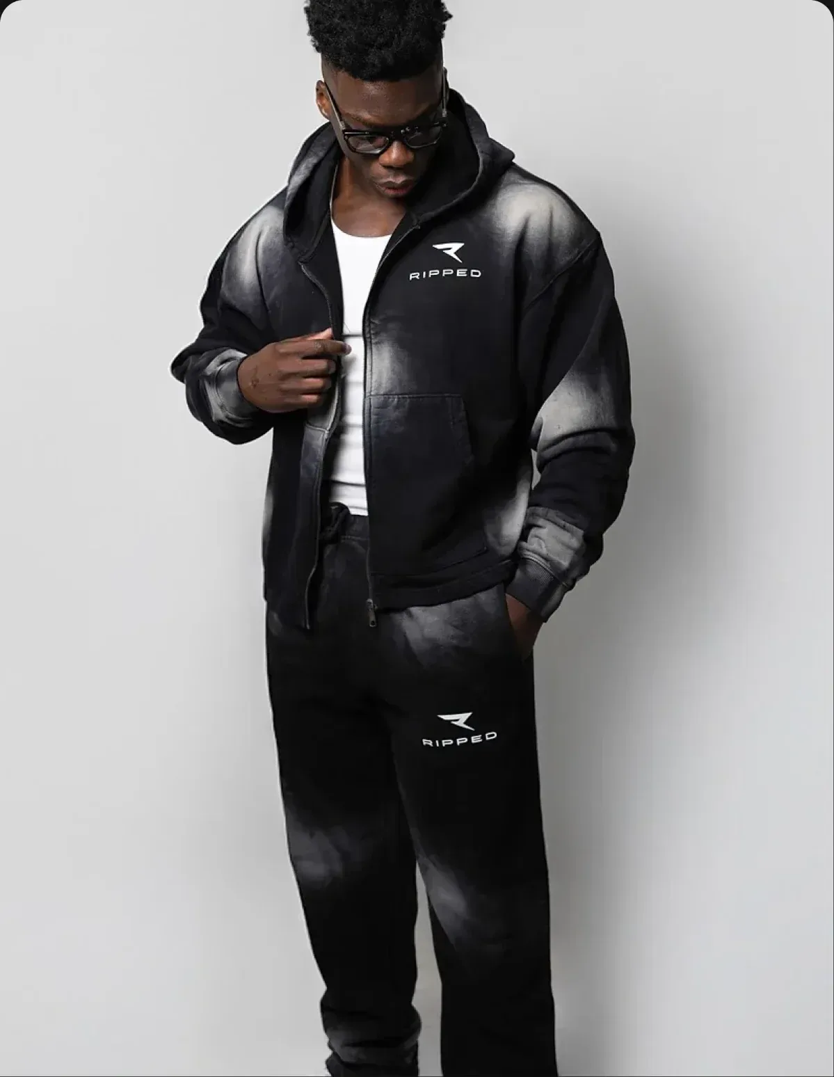 An athlete in a black RIPPED tracksuit